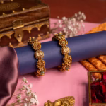 Antique gold bangles with lotus kundan centre, ruby stones and pearl outline