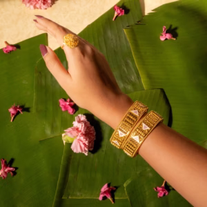 Pair of gold bangles with white enamel panels and pink flower detailing
